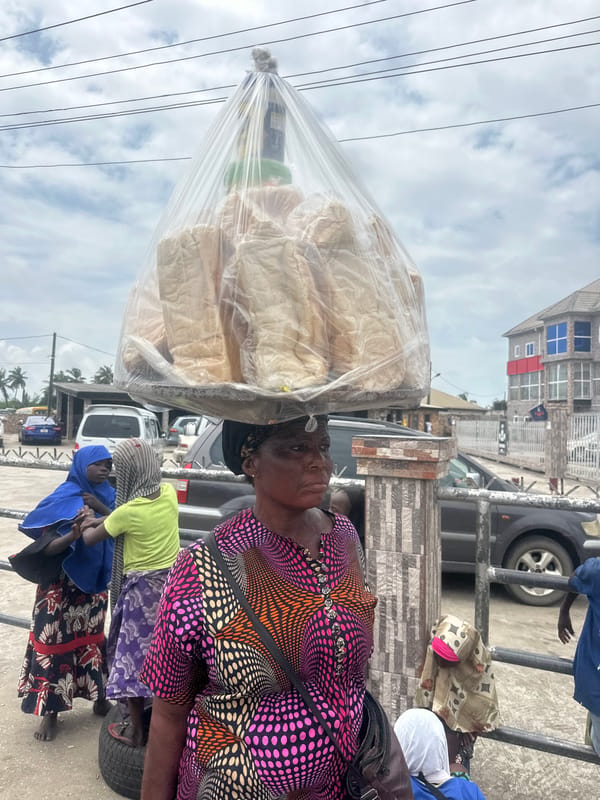 Market hustle and mural-making on a Badagry street