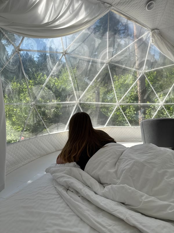 Woman enjoys glamping experience in geodesic dome, Nechkino Russia