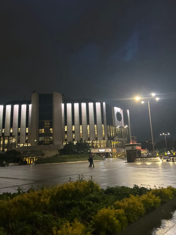Modern building with clock documented in nighttime Sofia
