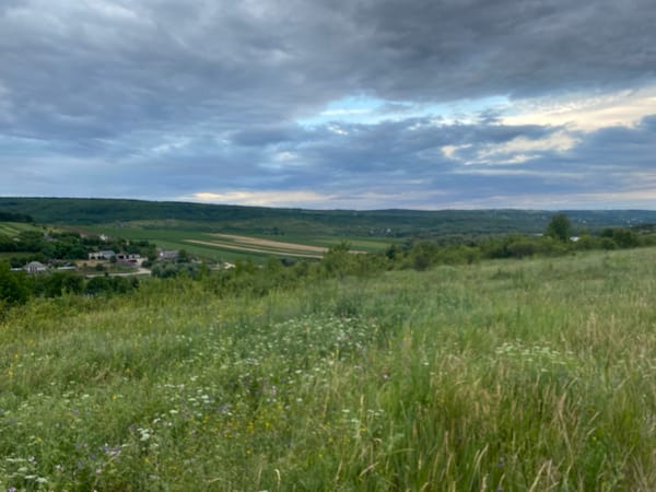 Rural fields and dirt paths on a cloudy evening in Horodca, Moldova