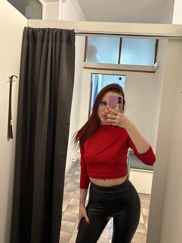 Woman takes selfies with cash-equipped phone in Simferopol dressing room