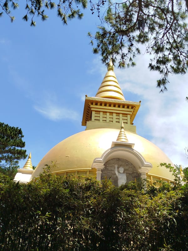 Visitor explores Golden Buddha Temple gardens in Da Lat, Vietnam