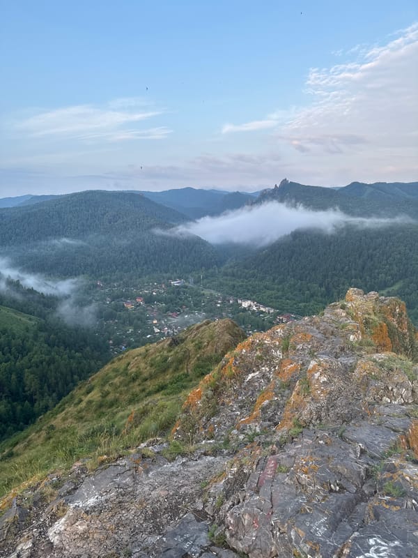 Krasnoyarsk blanketed in fog, seen from hilltops at sunset
