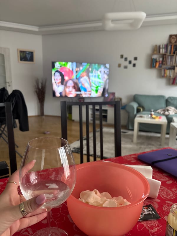 Woman enjoys wine and TV at home in Sofia