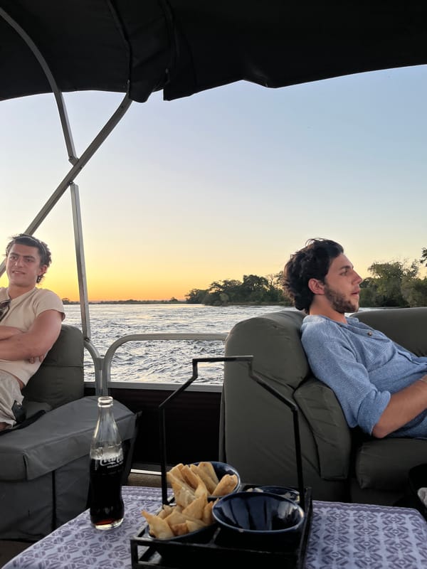 Men relax on boat near Victoria Falls, Zimbabwe