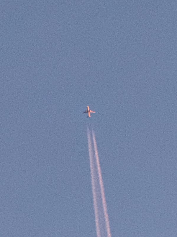 Planes, contrails, and a full moon over Norilsk skies
