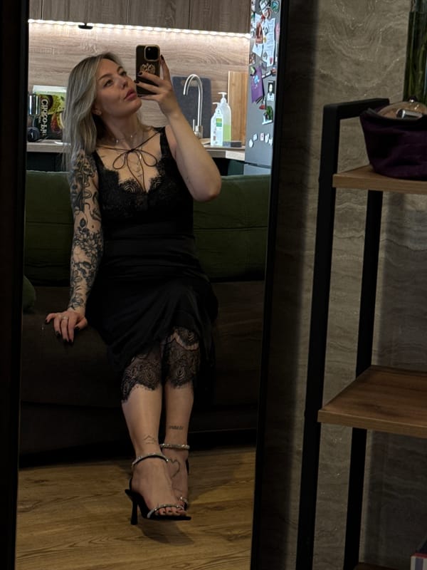 Woman takes mirror selfies in black dress in Krasnoyarsk