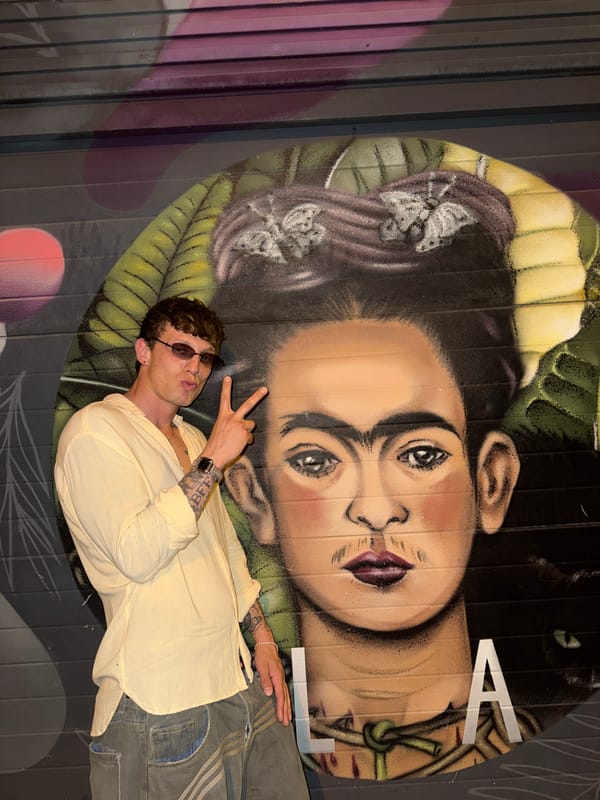 Peace sign in front of a Frida Kahlo mural, Barcelona