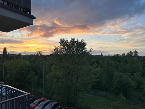 Twilight observations captured across Wrocław from elevated balcony position