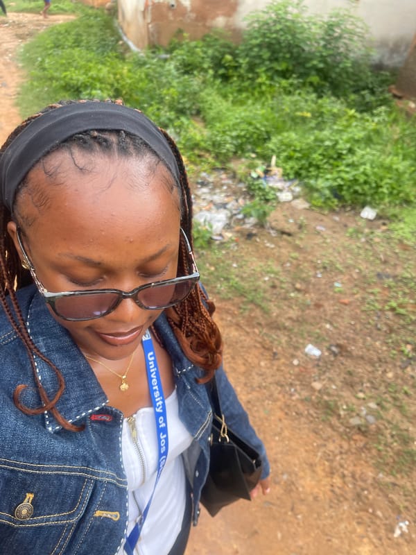 University of Jos student taking selfies on a dirt path in Rafin Par