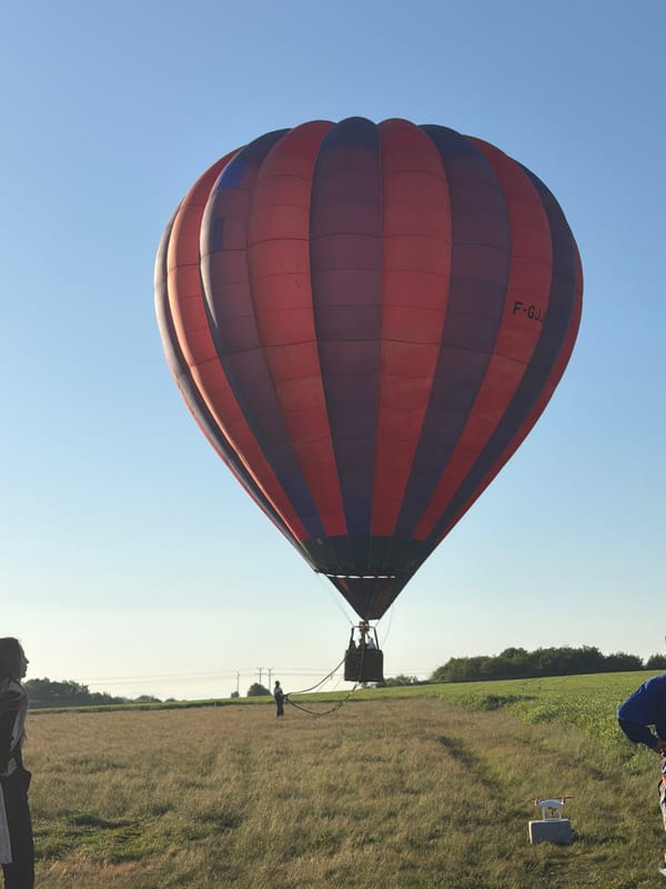 Hot air balloon rises over Bulgarian countryside