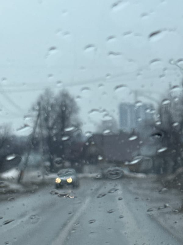 Rainy street scene viewed through window in Chaikovsky, Russia
