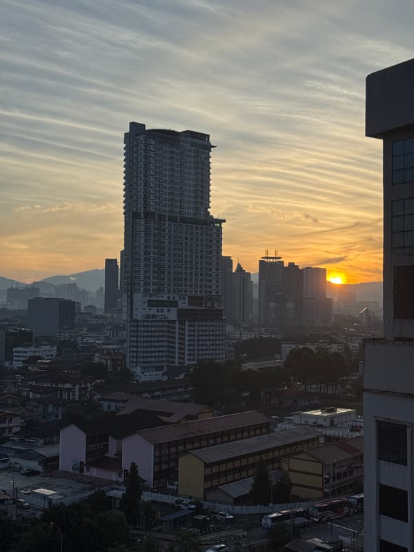 KL skyline at dusk and night, viewed from a high-rise room