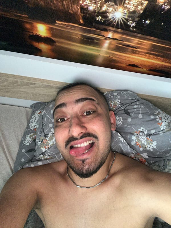 Man poses playfully on bed in Bulgarian village