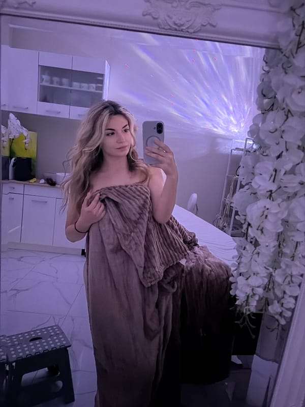 Woman enjoys banana snack during mirror selfie session in Budva