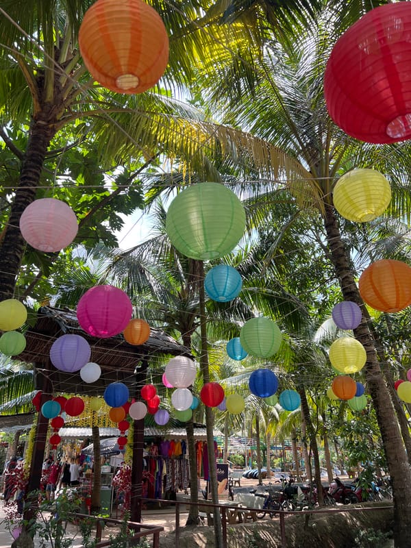 Man feeds fish from bridge in Vietnamese fishpond