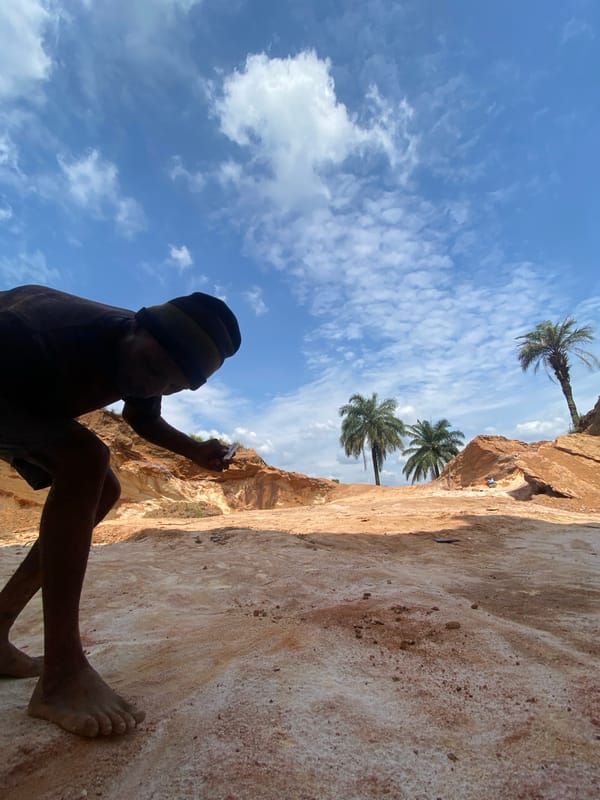 Barefoot climber scales rock face in Igbara, Nigeria