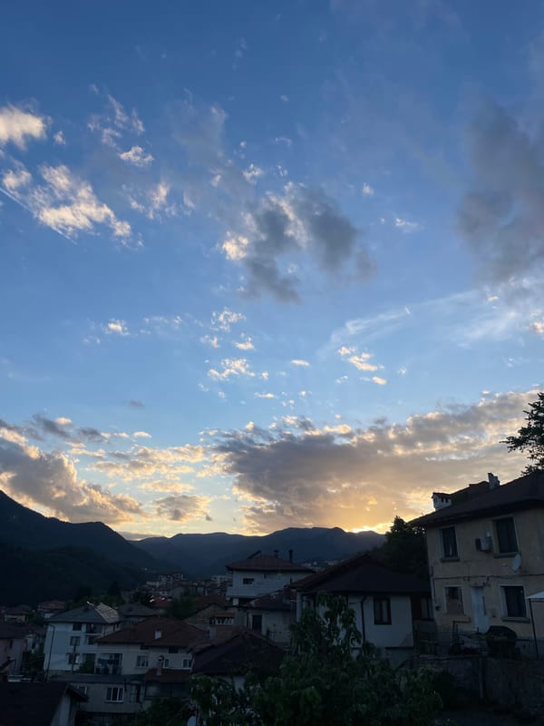 Cat watches over Smolyan from windowsill during golden hour