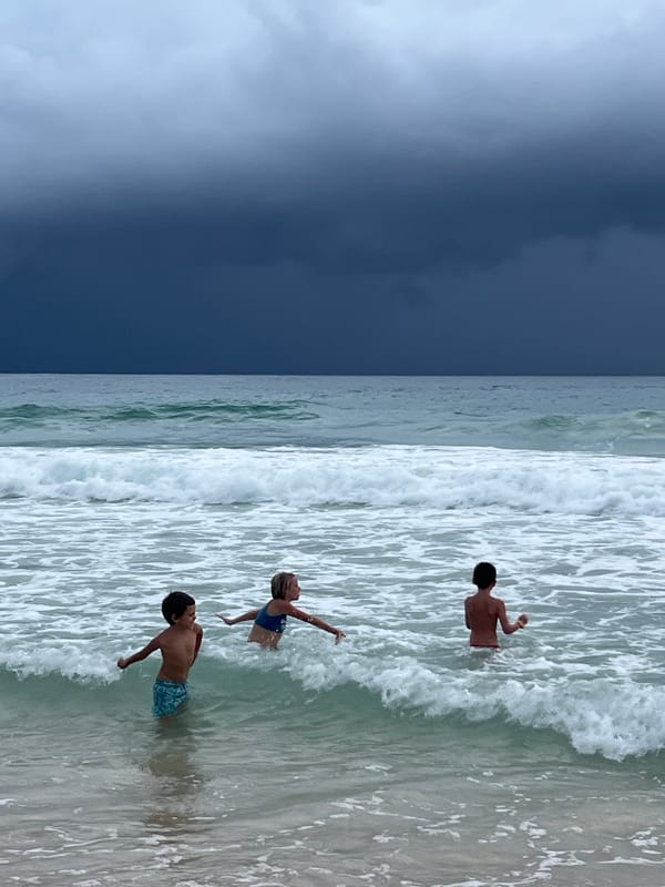 Stormy morning on a Choeng Thale beach, people still in the water