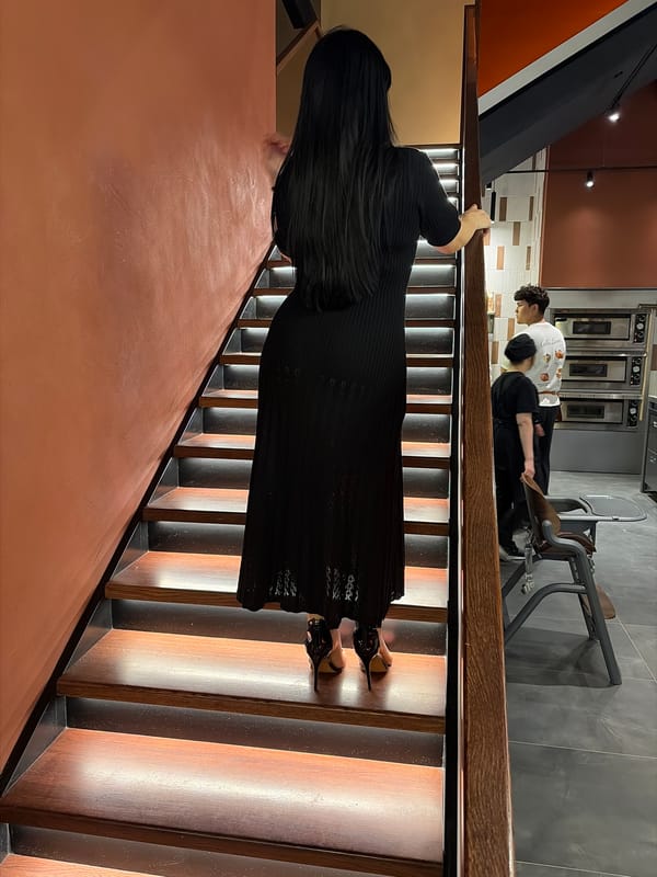 Woman in black dress documented during routine evening in Astana