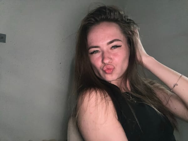 Portrait session captures young woman against gray wall