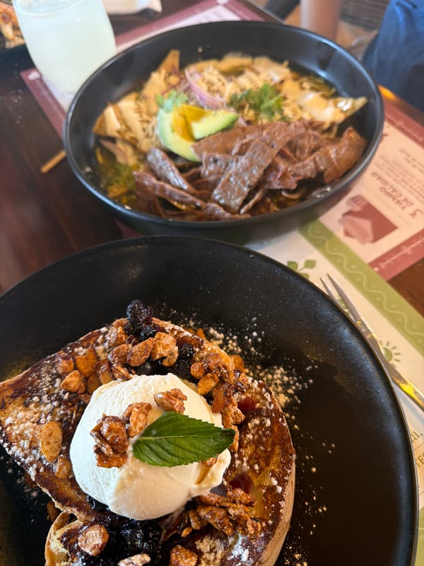 Restaurant meal documented in Puebla featuring chilaquiles and French toast