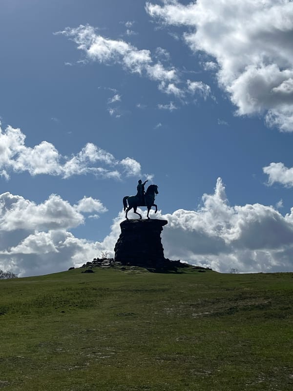 Equestrian statue and park pathway captured in UK village