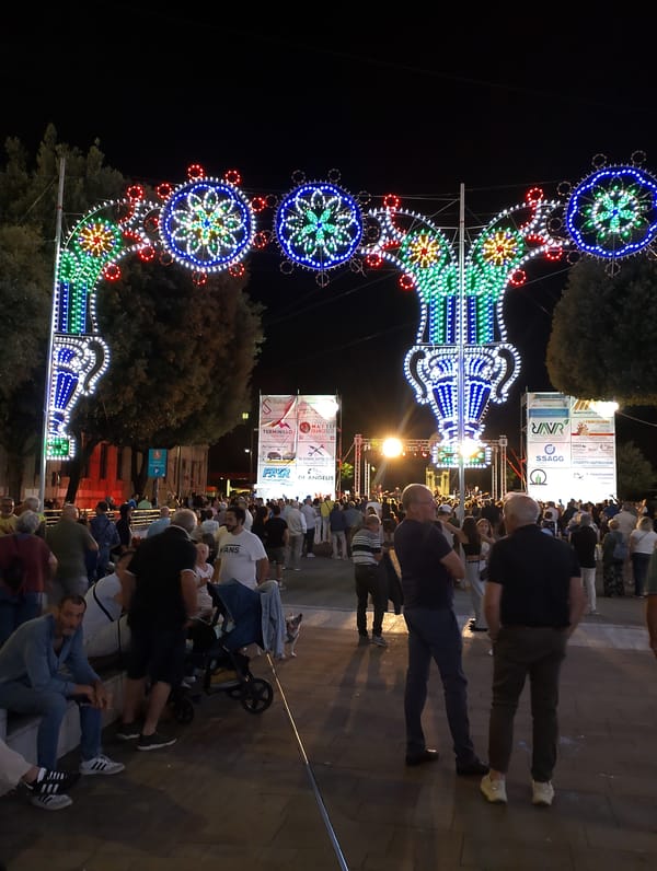 Evening festival lights and live stage setup in Rieti, Italy