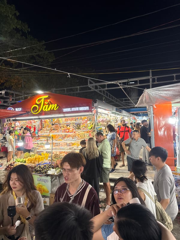 Night market activity and Dragon Bridge illumination in Da Nang