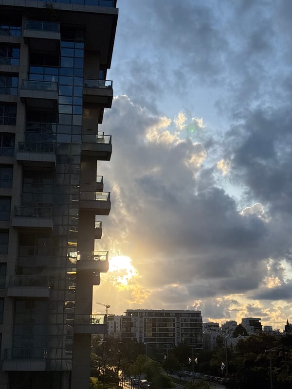 Modern building photographed against Tel Aviv skyline backdrop