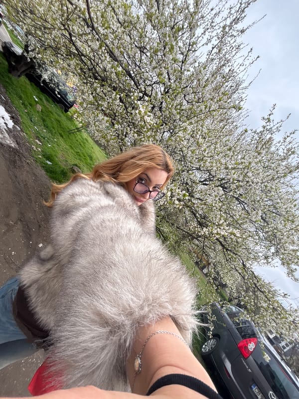 Woman takes spring selfie with blooming tree in Sofia