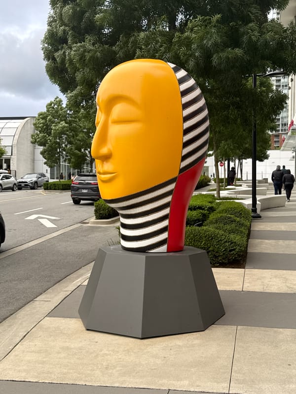 Colorful abstract head sculpture observed in urban Burnaby