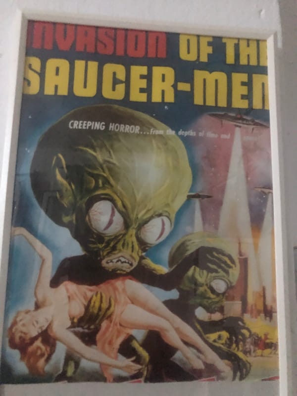 Vintage sci-fi movie posters and personal items documented
