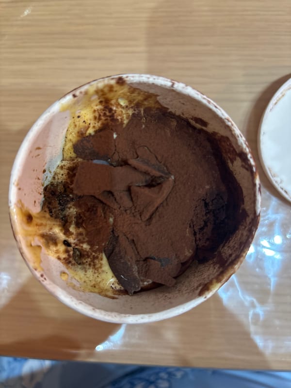 Tiramisu dessert captured in rustic serving dish in Rome