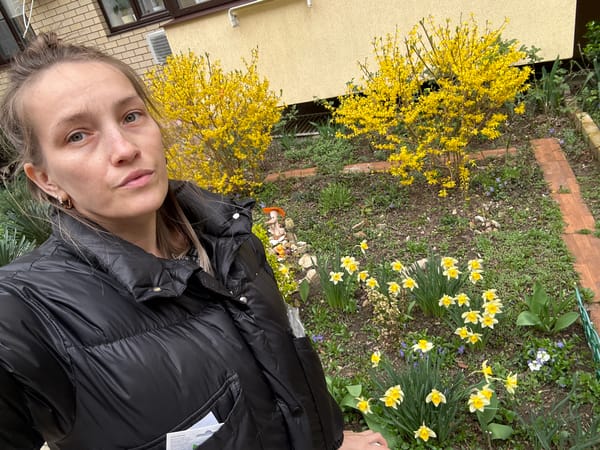 Woman enjoys spring blooms in Anapa garden