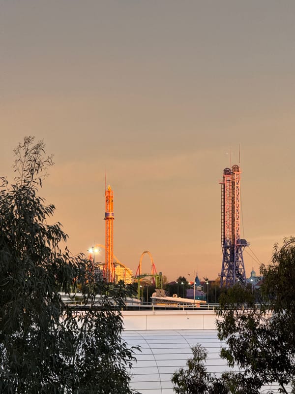 Amusement park with colorful towers documented at dusk in Sirius