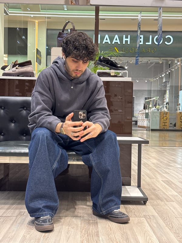 Young man sits on bench in Yerevan retail store