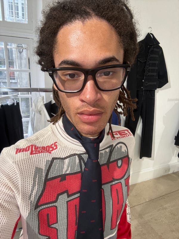 Person browsing clothing store in Paris holds mysterious wallet