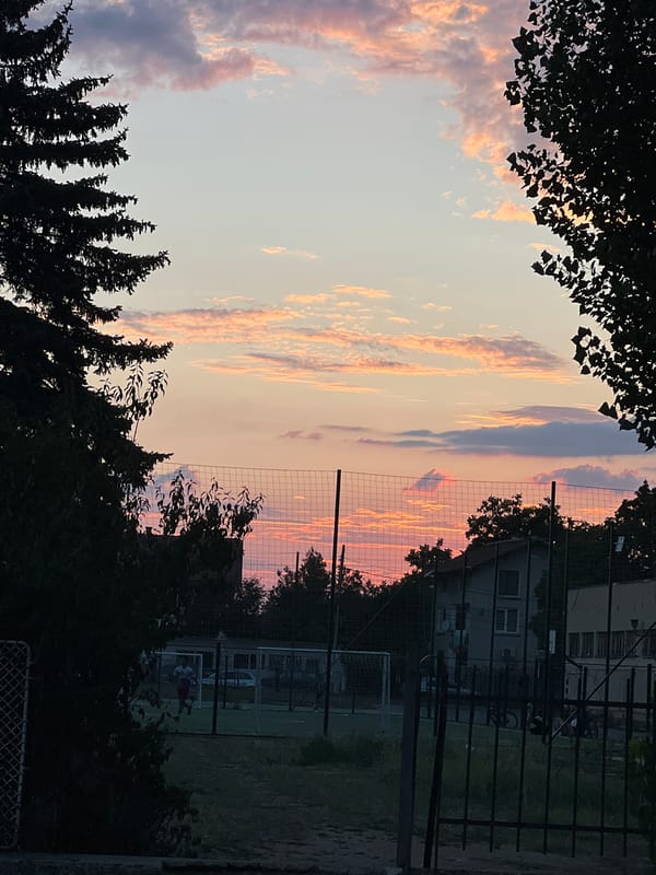 Sunset silhouette over an outdoor sports field
