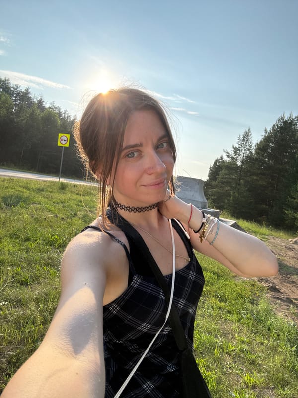 Outdoor selfie session in a sunny grassy setting