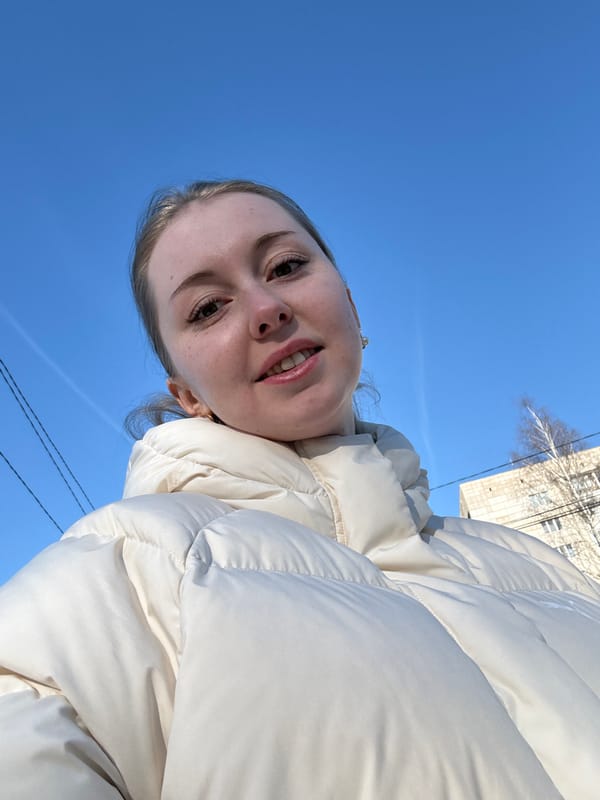 Woman photographed on urban path under contrail-streaked morning sky