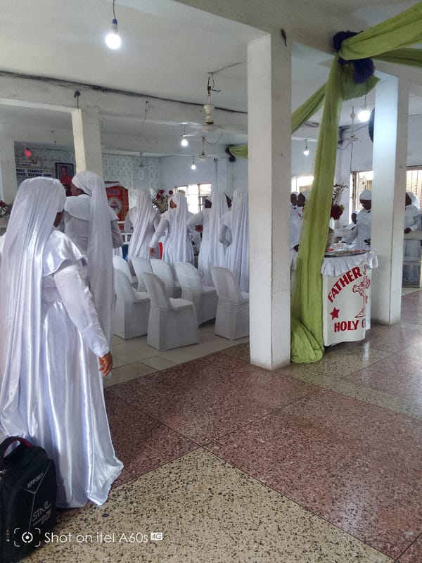 Women in white robes attend religious service in Lagos