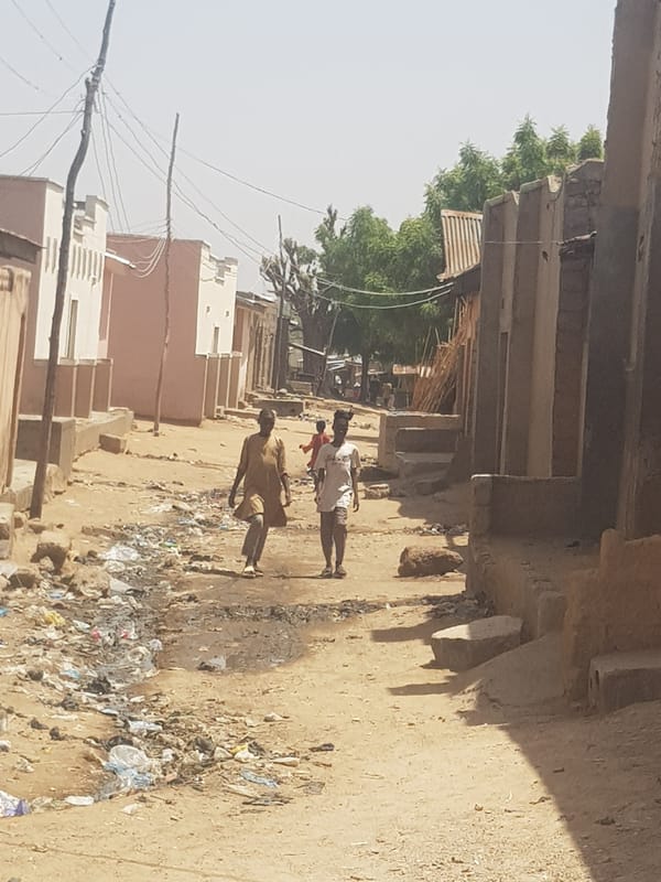 Daily life captured on unpaved streets in Nigerian towns