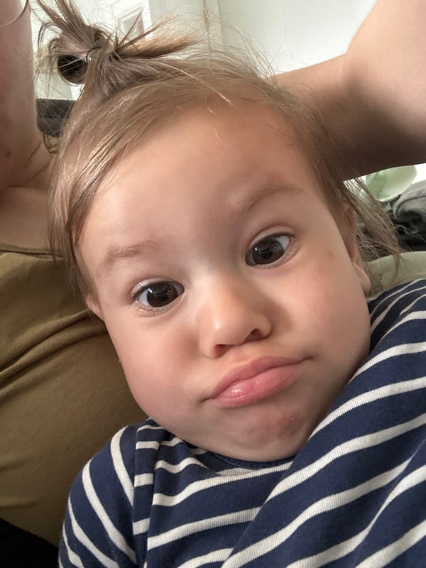 Mother and toddler share quiet morning moment on couch