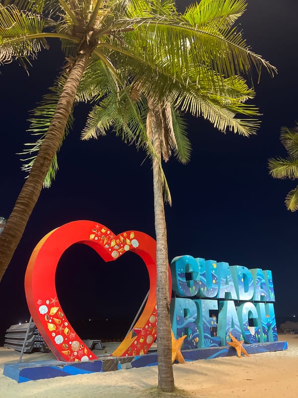 Hoi An beachfront at dusk and night, lit walkways and coastal decor