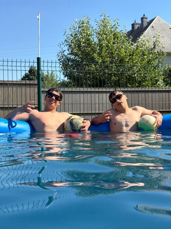 Young men enjoy afternoon pool games in Luxembourg backyard