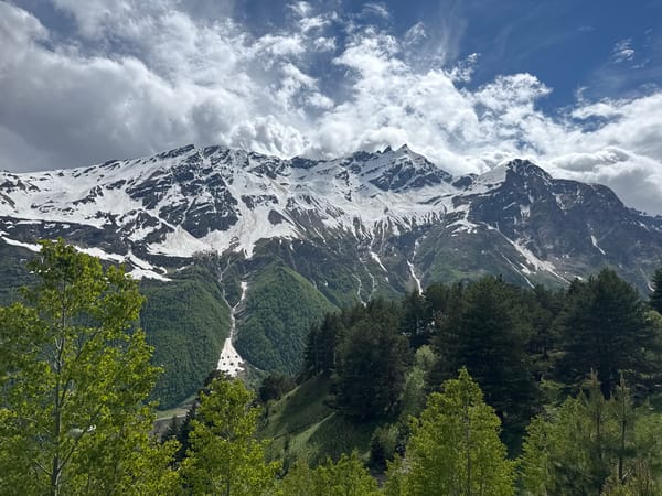 Hiking trail winds through alpine terrain near Terskol's mountain peaks