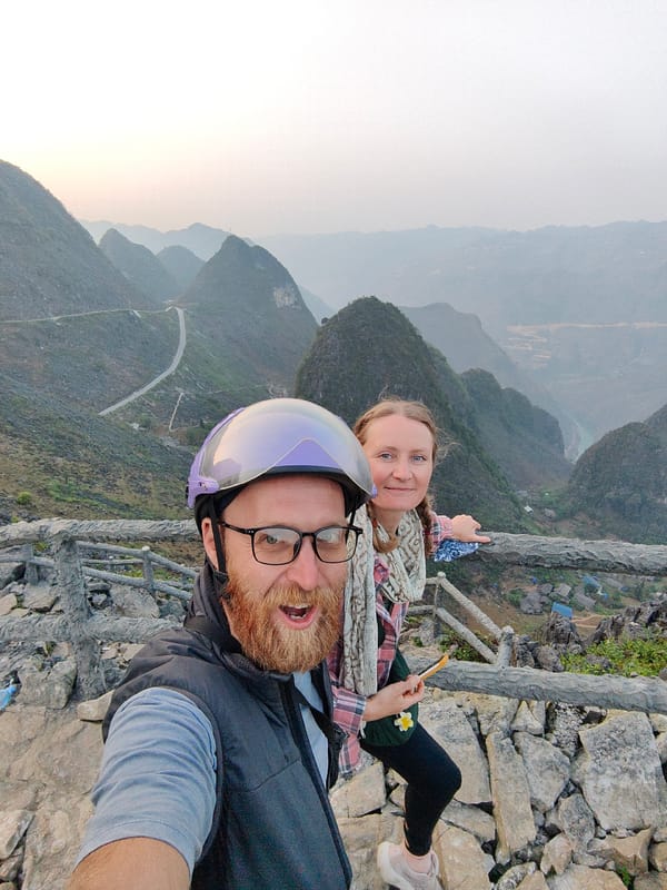 Tourists observe mountain valley scenery at Đồng Văn lookout