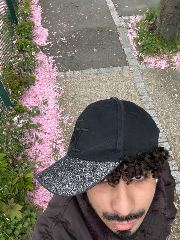 Person collects fallen cherry blossom petals in Orsay, France