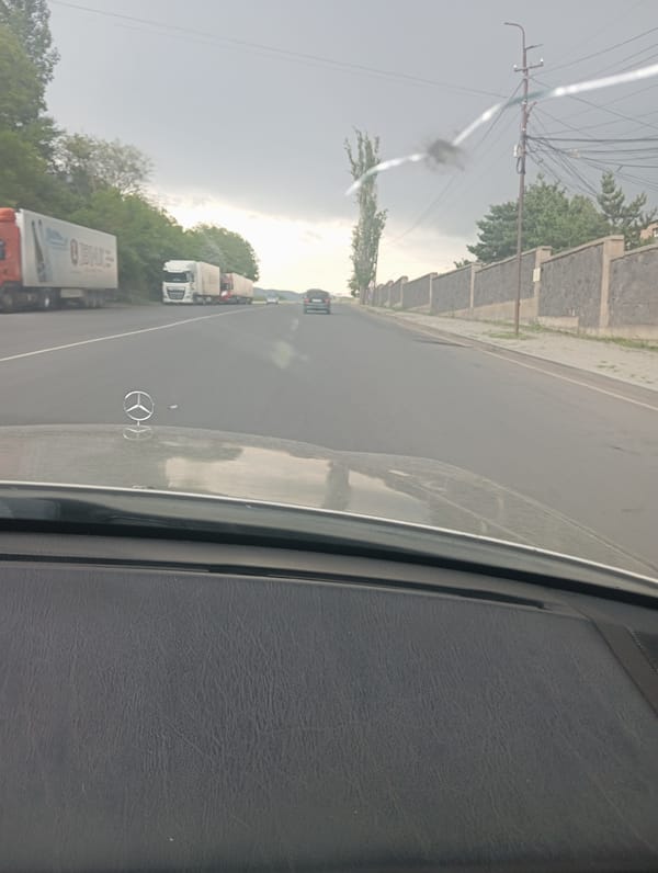 Rainy morning pause in Yeghegnadzor: roads, coffee, and grapevine patios